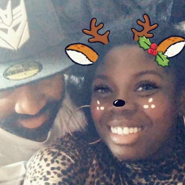 Carlene with a reindeer selfie filter, Bear in a Decepticon cap behind her